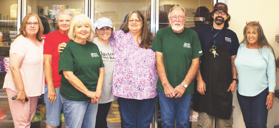 Southwest Ledger photo by Curtis Awbrey Lawton Food Bank staff and volunteers take a break between stocking and assisting recipients who are shopping for food and supplies on Tuesday, July 2. Pictured left to right: Executive Director Jeri Mosiman, Verna Landoll, Susan McCann, Leslie Pollacci, Candi Dawson, Larry Travis, Hobie Lassiter and Nancy Owens.