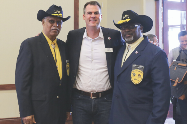Governor Kevin Stitt stands with troopers from the Lawton-Fort Sill Buffalo Soldiers 9th and 10th Cavalry Association after a town hall meeting in Lawton. Pictured, left, is Roy Achong, and, right, is Tony Washington.