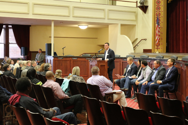 Oklahoma Gov. Kevin Stitt speaks in a town hall style meeting about progress made by state agencies during the Lawton stop of the Top 10 Cabinet Tour. Governor Stitt has attended approximately 300 town hall meetings across the state. Seated right are John Budd, Secretary of Agency Accountability; Blayne Arthur, Secretary of Agriculture; Chip Keating, Secretary of Public Safety; Ben Robinson, Secretary of Military and Veterans Affairs; and Lieutenant Governor Matt Pinnell, Secretary of Tourism and Branding