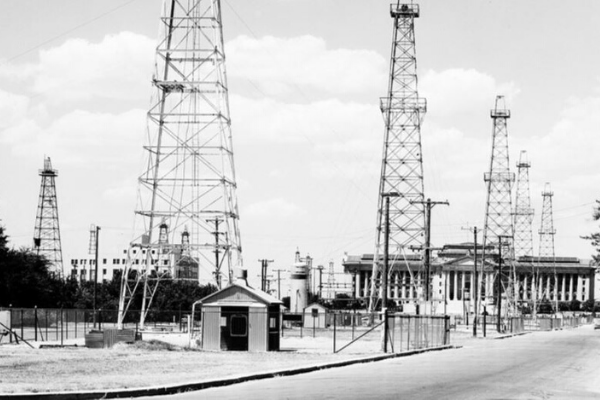 Photo courtesy of American Oil and Gas Historical Society                   Oil derricks operating on the Oklahoma State Capitol grounds.