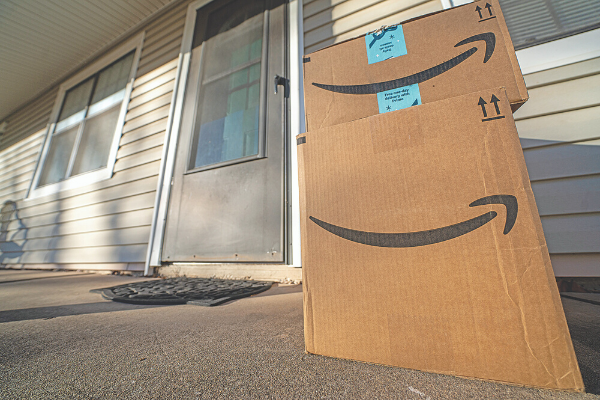 Southwest Ledger photo by Chris Martin Packages bearing the Amazon logo are seen on a resident’s porch. A bill by Rep. Ross Ford would make stealing such packages a state crime.