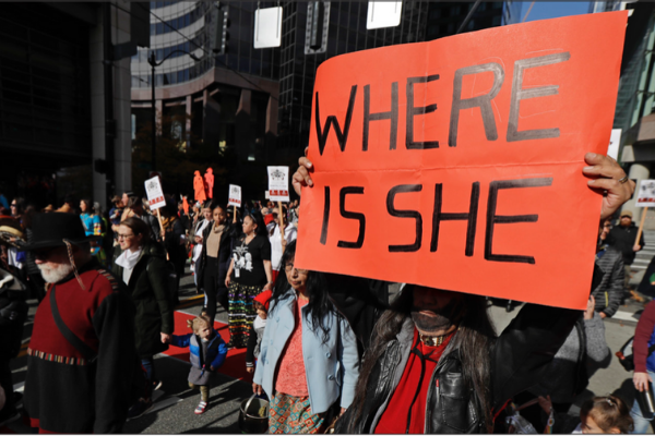 Dennis Willard, of Bellevue, Wash., carries a sign that reads "Where Is She" as he marches in support of missing and murdered indigenous women during a rally to mark Indigenous Peoples' Day in downtown Seattle, Monday, Oct. 14, 2019. The observance of the day was made official by the Seattle City Council in 2014, and it takes place annually on the federal holiday of Columbus Day. AP Photo/Ted S. Warren