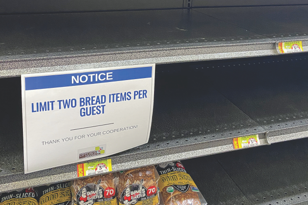 A sign informs customers to limit themselves to two bread items inside the Uptown Grocery in Edmond.