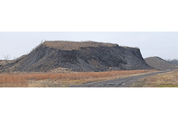This mountain- size coal mining spoil pile south of Stigler is being recycled: its shale is being sold, probably for use in road construction. Photo by Bryan Painter