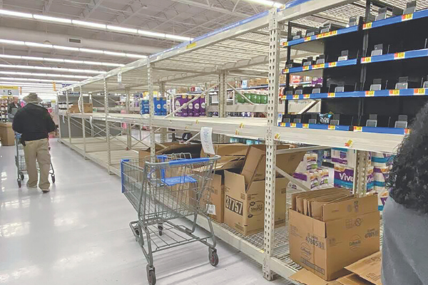Just a few packages remain on the shelves five minutes after associates stocked two pallets of toilet paper at the Altus Walmart Supercenter Friday, March 13. Due to high customer demands, Walmart enforced a two-package limit on toilet paper and cases of bottled water. Associates scrambled to stock toilet paper and other items as customers picked the shelves clean. Four pallets of toilet paper were purchased within 20 minutes, one associate stated. Ledger photo by Curtis Awbrey