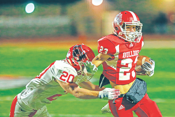 Cache’s Hunter Tate attempts to break a tackle during a football game against Elgin Nov. 1, 2019. Rick Endicott Photography, file Cache’s Hunter Tate attempts to break a tackle during a football game against Elgin Nov. 1, 2019.