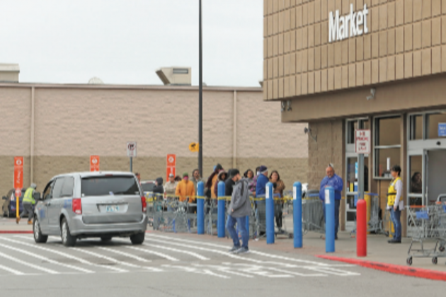 Ledger file photo by Jay DeSilver Customers wait in line to enter a Lawton Walmart Supercenter in early April after COVID-19 guidelines and restrictions were put in place. Walmart and similar big-box stores have now had their mandated occupancy limits raised.