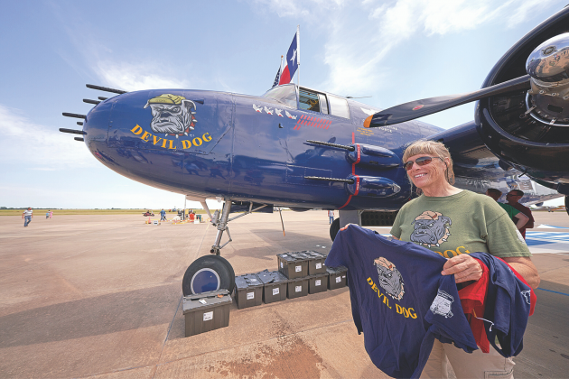 Ledger photo by Chris Martin        Pilot Beth Ann Jenkins stands in front of the “Devil Dog” B-25 at the Wings and Wheels Fly-in and Car Show in Chickasha last Saturday.