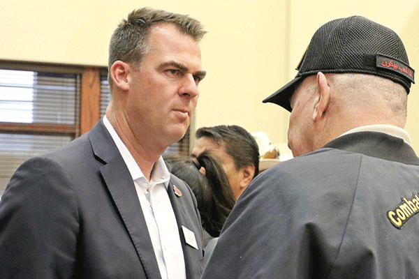 Oklahoma Gov. Kevin Stitt, left, listens to an attendee after a town hall meeting in Lawton during the governor’s Top 10 Cabinet Tour in October 2019. Ledger file photo by Curtis Awbrey
