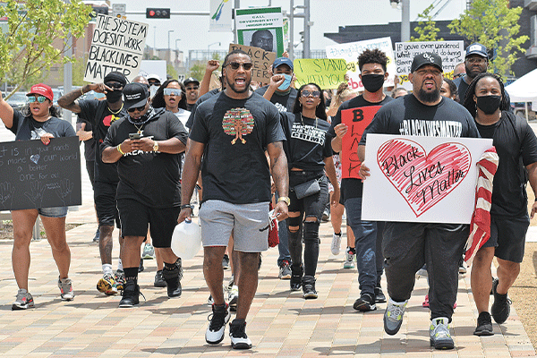 Justin Broiles, center, marches with a group during a recent Black Lives Matter rally in Oklahoma City. Ledger photos by Michael Kinney