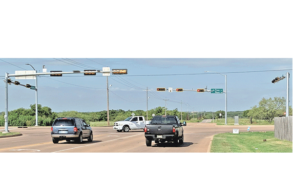 Motorists drive through the intersection of Flower Mound Road and Cache Road in east Lawton, where new traffic signals have been installed. Ledger photo by Mike W. Ray