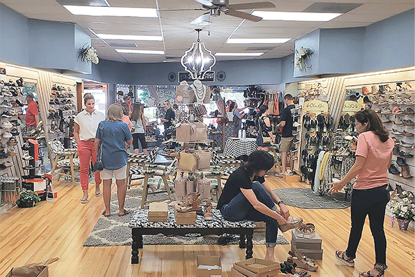 Patrons visit The Booterie Inc. in Altus during a June grand reopening after a remodeling of the store.