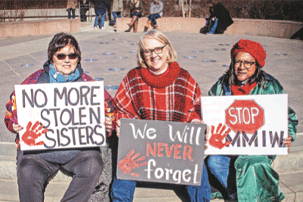 Women hold signs in protest of missing and murdered indigenous women during an annual Women's March in Tulsa Jan18.