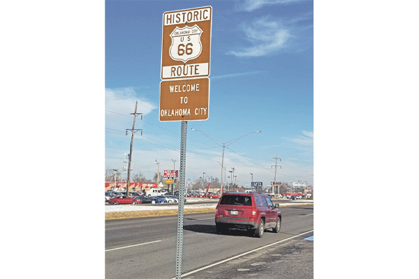 Ledger photo by Andrew W. Griffin A motorist passes by a historic Route 66 sign at an Oklahoma City boundary.