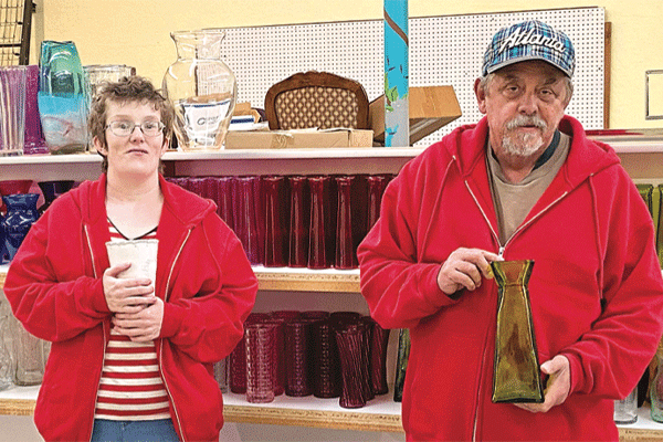 Ellie Williams and Ernie Kelley,Think Ability employees, stand in front of cleaned and sanitized Valentine's Day vases inside the Nonprofit's Duncan store. Ledger photo by Curtis W. Aubery 