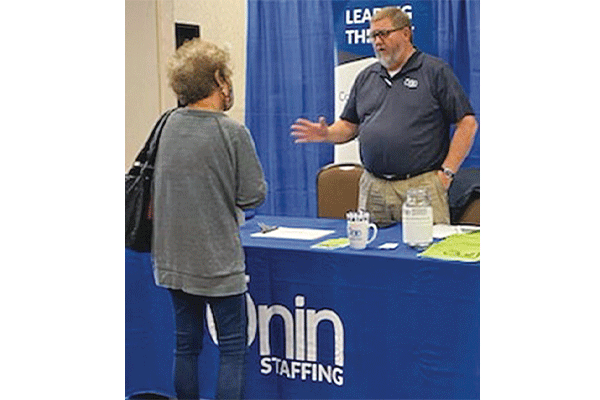 LEDGER PHOTO BY KYLETTA RAY A representative of Onin Staffing in Oklahoma City speaks with a prospective job seeker during the career fair held May 14 in Lawton, hosted by the Oklahoma Employment Security Commission.