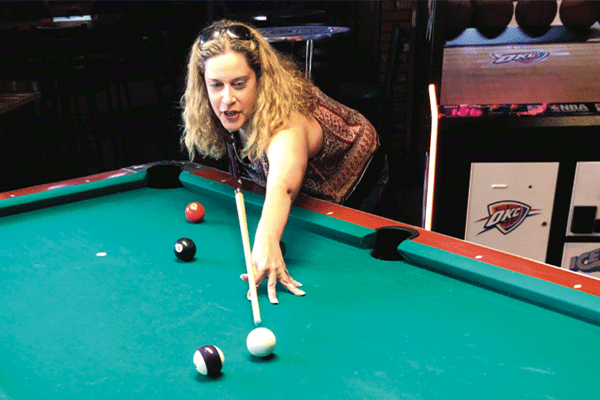 Jessica Cassidy shoots pool at Red Dirt bar and Grill. Photo by Tim Farley 