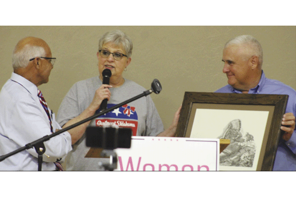 For his 12 years of service, Rep. Charles Ortega, House District 52 receives a retirement gift from Deb Davis, president of Southwest Oklahoma Republican Women, and former President Pro Tem Mike Schulz, Senate District  38, during the 2020 Beans and Baskets GOP fundraiser.