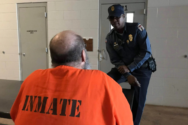 Capt. Kory Conley speaks with an inmate at Joseph Harp Correctional Center in Lexington. (Courtesy Oklahoma Department of Corrections)