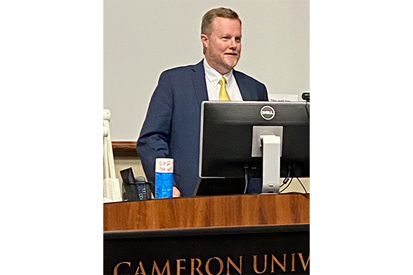 Chad Wilkerson, branch executive of the Kansas City Federal Reserve’s Oklahoma City office, addresses the audience during a Nov. 18 forum at Cameron University. Wilkerson joined Lawton businessmen Phil Kennedy and Hossein Moini for a forum about the global supply chain disruption.