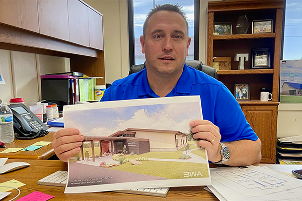 Flower Mound Public School Superintendent Dax Trent displays an artist's rendition of the district's proposed early childhood center during an Oct. 13 interview. Patrons of the district approved on Tuesday a $2 million bond issue to help cover the district's share of the cost, estimated at $2.8 million to $3 million. Eric Swanson/Ledger photo