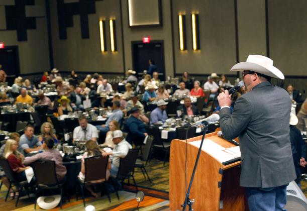 Auctioneer Dustin Glover works the crowd during the Comanche County Saddle & Sirloin Club's Take Stock in Kids dinner and live auction July 16th in Lawton. Photos by Rip Stell/For Southwest Ledger