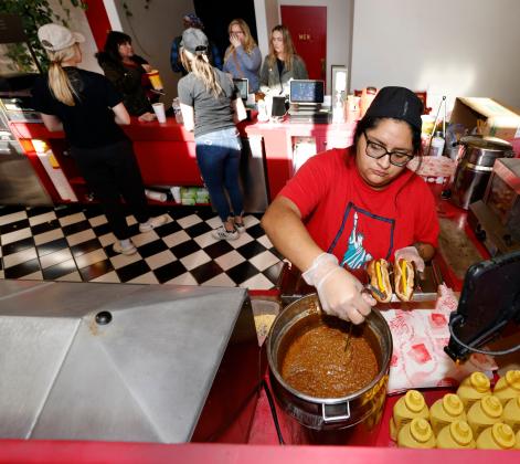 Gabby Nasel makes chili dogs for patrons at Saturdays matinee screening of Avatar at the Liberty Movie Theatre in Carnegie. RIP STELL | SOUTHWEST LEDGER