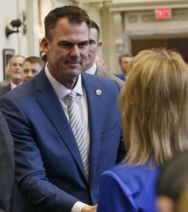 Oklahoma Governor Kevin Stitt greets a member of the Legislature just before he delivers his State of the State speech Monday at the State Capitol. RIP STELL | SOUTHWEST LEDGER