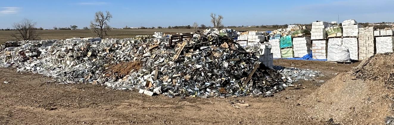 Numerous pallets of hand sanitizer and a large pile of burned debris still remain at the old H&B Manufacturing site in Ninnekah. CURTIS AWBREY | SOUTHWEST LEDGER