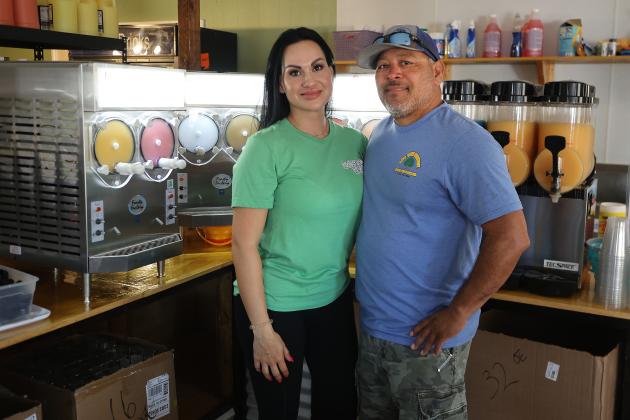Bayou Booze owner Kenya Villarreal and husband J.R. Villarreal stand in front of the daiquiri mixers at the store, 115 W. Walker St., in Altus. She opened Bayou Booze on March 29. HUGH SCOTT JR. | SOUTHWEST LEDGER
