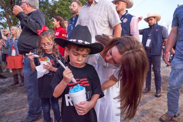 Christopher Bryan | Southwest Ledger From the concession stand, Piper Stitt serves snow cones to 2024 presidential hopeful Florida Gov. Ron DeSantis; her father, Oklahoma Gov. Kevin Stitt and others during the Ponca City Rodeo. CHRISTOPHER BRYAN | SOUTHWEST LEDGER