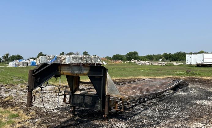 Pictured are charred remains of a gooseneck trailer, and ashes from pallets of flammable hand sanitizer stacked on it, that were destroyed in the June 2 fire at the former H&B Machine and Manufacturing site in Ninnekah. CURTIS AWBREY | SOUTHWEST LEDGER