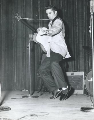 A 21-year-old Elvis Presley swings his hips during a 1956 performance in Oklahoma City. The photo of Elvis, captured by photographer Mandell Matheson has only been published once before. PHOTO COURTESY OF KAREN MATHESON