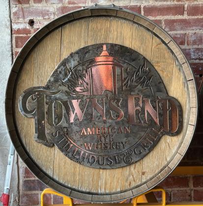 A specially designed metal logo is attached to the end of wooden barrels employed in “Town’s End” operations. Owner Chet Hitt buys American white oak barrels from The Barrel Mill cooperage in Minnesota. The barrels are charred to Level 3 or 4, he said, to age whiskey and give it an oak color, aroma, and smoky flavor. MIKE W. RAY | SOUTHWEST LEDGER