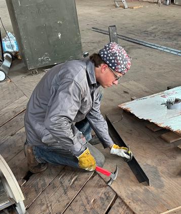 Jacob Compton of Blanchard scores a piece of steel trim prior to drilling holes for rivets that will attach the piece to a window frame in the Savoy Hotel. Compton is a student at the Canadian Valley Technology Center. MIKE W. RAY | SOUTHWEST LEDGER