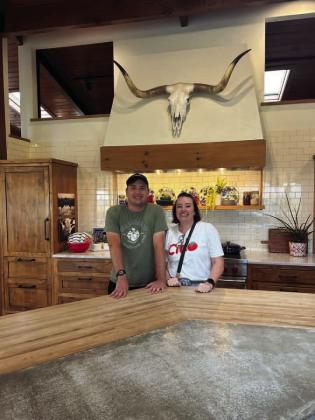 During a family outing, Jake and Melissa Finck pose for a photo at Ree Drummond’s Pioneer Woman kitchen studio in Pawhuska. Photo by James Finck, Ph.D.