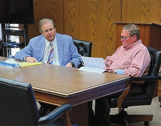 Comanche County District 1 Commissioner John D. O’Brien, right, confers with his defense attorney, John Zelbst, in a courtroom on March 13. Mike W. Ray | Southwest Ledger