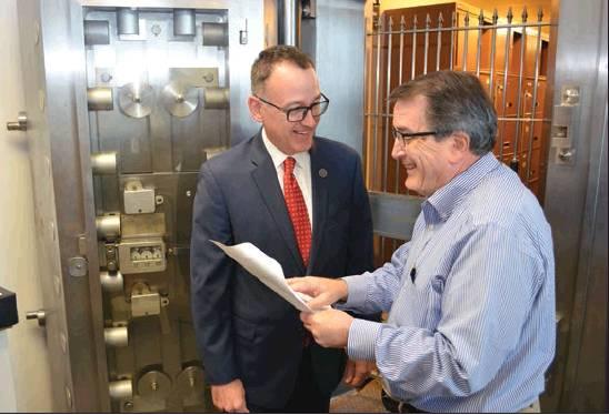 Photo courtesy of State Treasurer’s office State Treasurer Randy McDaniel, left, and Deputy Treasurer Tim Allen are shown in front of the treasurer’s vault at the state Capitol building. A massive renovation project is displacing McDaniel’s office for the next eight months.