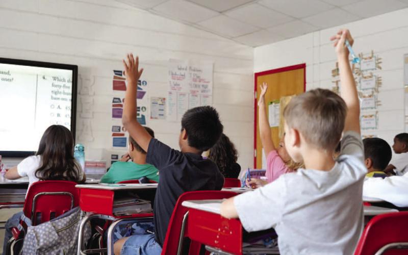 Third grade students from Bishop Elementary raise their hands during a lesson in mathematics. Ashley Payne | Southwest Ledger