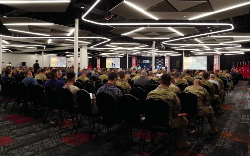 Ashley Payne | Southwest Ledger ABOVE: Military members and industry leaders hear Col. Sam Nirenberg’s keynote speech Wednesday during the FIRES Symposium at the FISTA Innovation Park. The conference “is the largest FIRES-related conference in the nation, with attendees from 40 countries,” said FISTA President and CEO Dr. Krista Ratliff.