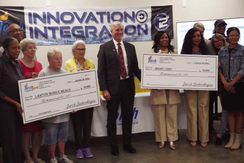 Eric Swanson | Southwest Ledger From the left, representatives of Lawton Mobile Meals, Torch Technologies and Might Community Development and Resource Center pose for a photo Oct. 29 at the FISTA Innovation Park. Torch Technologies, which is a tenant of the Innovation Park, presented $10,000 checks to Lawton Mobile Meals and Might CDRC following a ribbon-cutting ceremony at the Innovation Park.