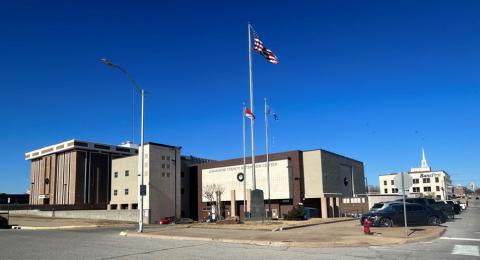 Flags fly high in the cloudless sky above the Comanche County Courthouse. File Photo