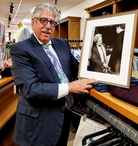 Southwest Ledger photo by Debi DeSilver       Eddie Hamra and his grandson Kipton Wright, 8, hanging out on a summer’s day at Edward’s Men’s Wear located at 405 SW C Ave. in Lawton. Eddie is holding a plaque from the Lawton-Fort Sill Chamber of Com- merce, which honored Edward’s Men’s Wear as the “Small Family Owned Business of the Year” in 2016.