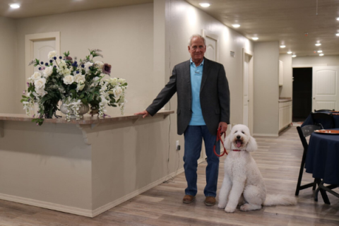 Southwest Ledger photos by Lisa Carroll                          Jim McWhirter and his therapy dog, Buddy, are shown in the lobby of the new Cyril Retirement Community during a tour of the facility in September.