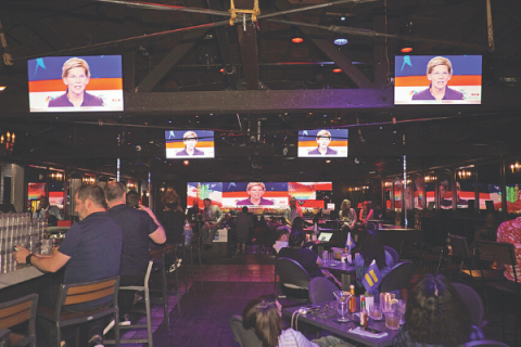 Patrons at a restaurant and bar in West Hollywood, Calif., watch a past debate of Democratic Party presidential candidates.