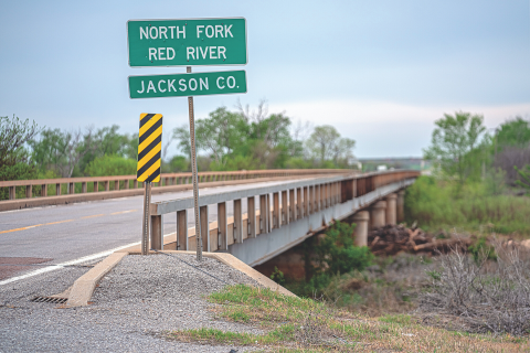Ledger photo by Chris Martin The bridge on SH-5 that spans the North Fork of the Red River at the Jackson/Tillman county line west of Tipton, along with a nearby overflow bridge, are scheduled to be replaced. The Oklahoma Transportation Com- mission awarded a $7,189,781 contract on the project to Bridgeco Contractors of Wellston. The existing structures will remain standing while a new two-lane bridge is built, but will be demolished after the work is finished, according to Jackson Mayberry of the Oklahoma