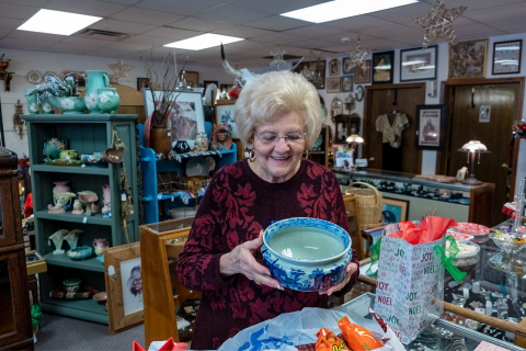 In this December 2018 photo, Helen Jones looks at an antique bowl inside Antiques by Helen, 412 SW Lee Blvd. in Lawton.
