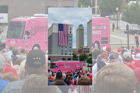 Ledger photo by Jeremy Robbins A giant American flag hangs from the top of a building as attendees gather for a rally for President Donald Trump inside the nearby BOK Center in downtown Tulsa last Saturday. 