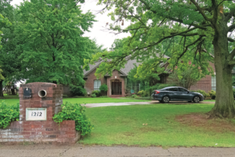A vehicle is parked in the driveway at 1212 Mockingbird Lane in Guthrie.