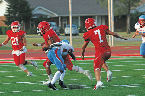 Rivers Johnson (1, in red) eludes a tackle as he returns an interception for Elgin High School against Eisenhower in 2019.